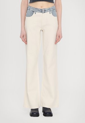 Cream-colored flared jeans with a denim-accented waistband and pockets, made of cotton fabric, featuring visible stitching.