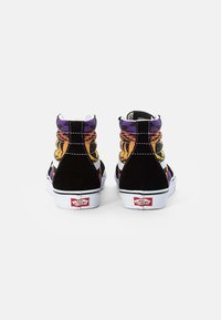 High-top sneakers in black suede with a colorful patterned fabric upper featuring purple, orange, and yellow accents, white soles, and logo.