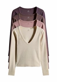 Dlhé rukávy s výstrihom do V v béžovej, mauve, prašnej ružovej a tmavofialovej farbe. Žebrovaná textúra, mäkký materiál, s visačkou na golieri.