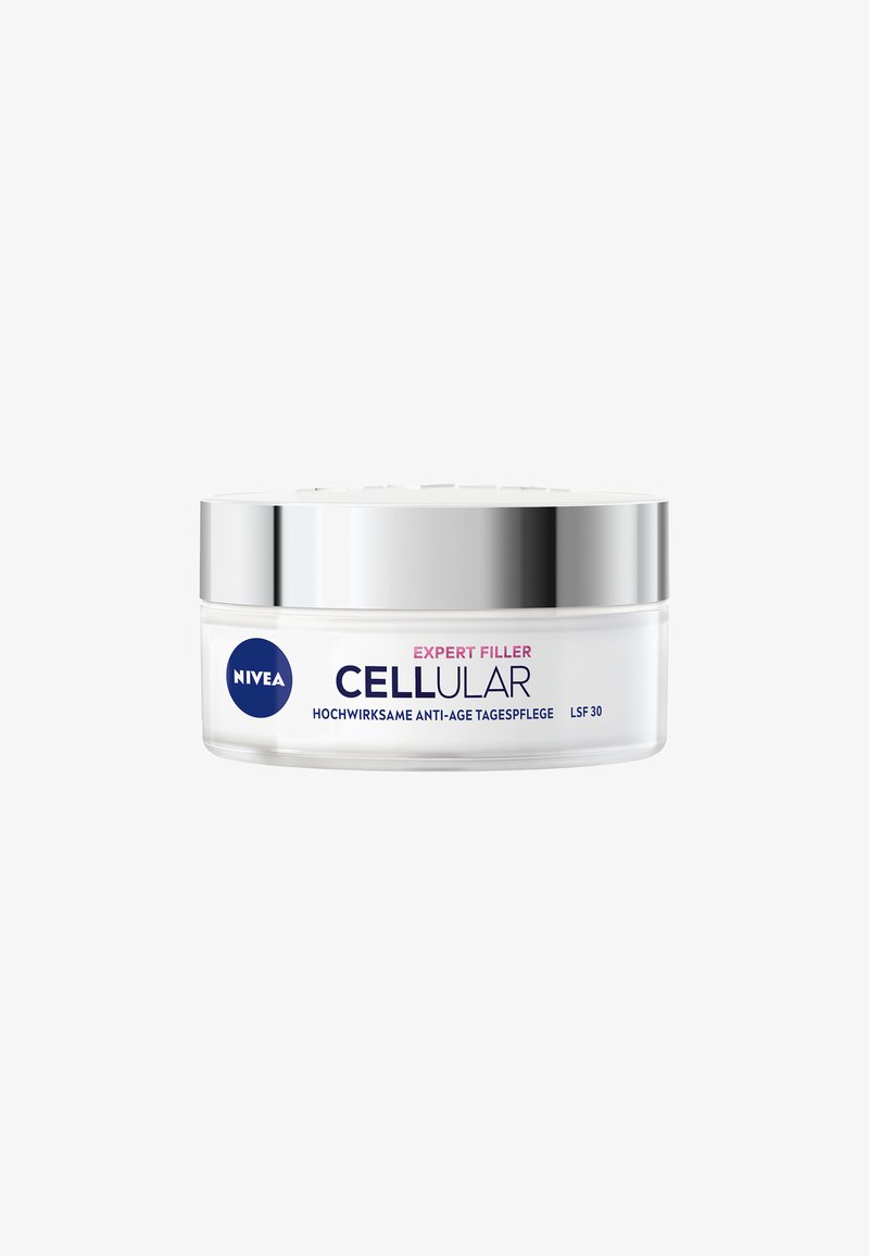 NIVEA Cellular Expert Filler cream in a transparent jar with a silver lid, featuring blue and pink text. Textured surface on lid.