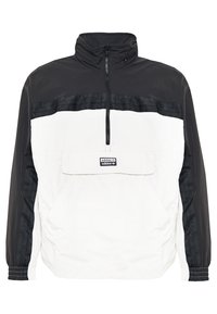 Black and white pullover jacket with a high collar, half-zip front, elastic cuffs, and a horizontal logo band across the chest.