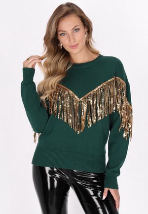 Groene gebreide sweater met gouden pailletten franjes in een V-vorm over de borst. Lange mouwen en geribde manchetten. Heeft een ronde hals.