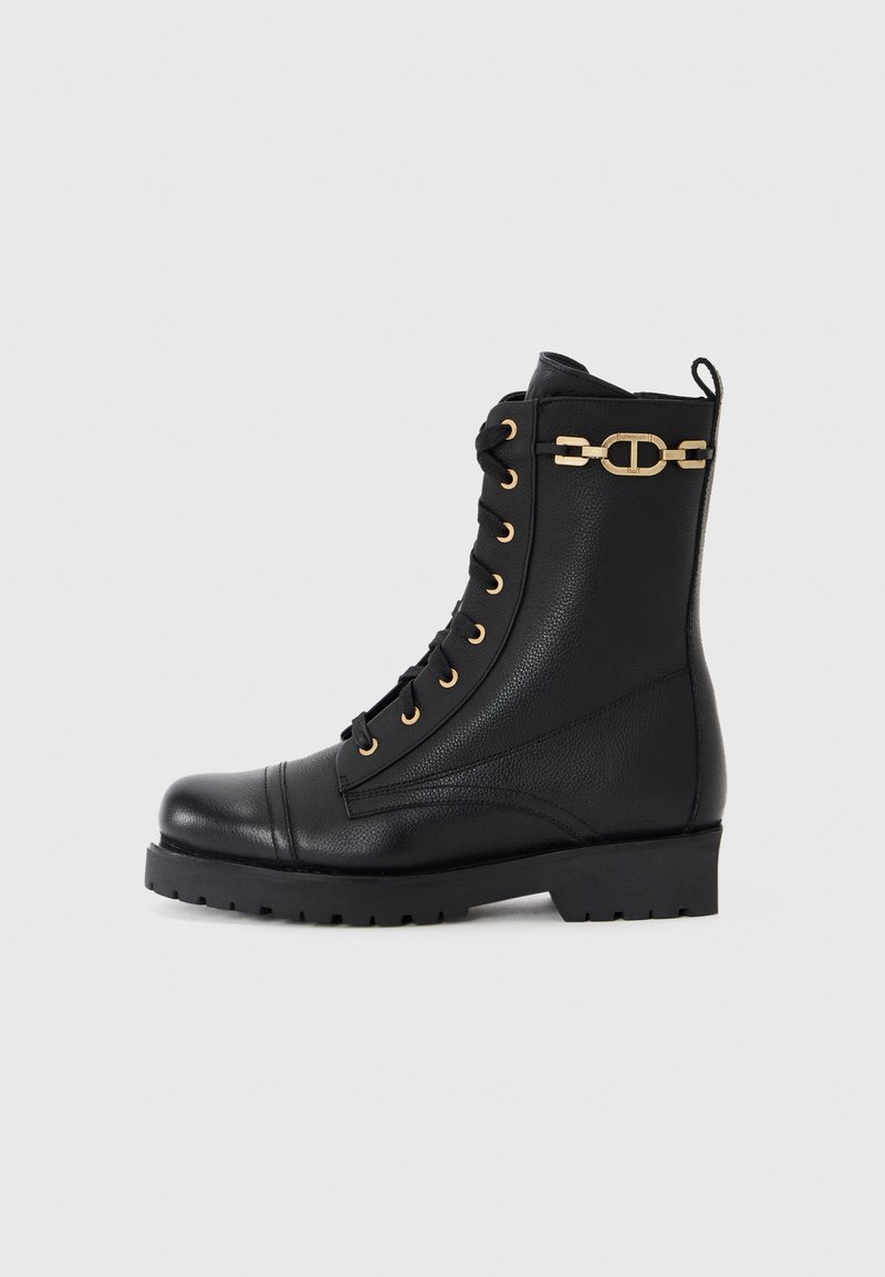 Black leather lace-up ankle boots with gold hardware details and a textured surface. Features a chunky sole and a round toe.