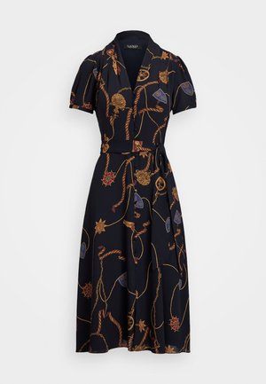 Robe portefeuille marine avec un col classique, des manches courtes bouffantes et une ceinture. Présente un motif de chaînes multicolores et d'emblèmes sur l'ensemble.