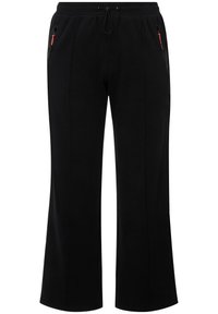 Černé tepláky vyrobené z měkké látky, s elastickým pasem, šňůrkou na stažení a dvěma bočními kapsami na zip s červenými akcenty.