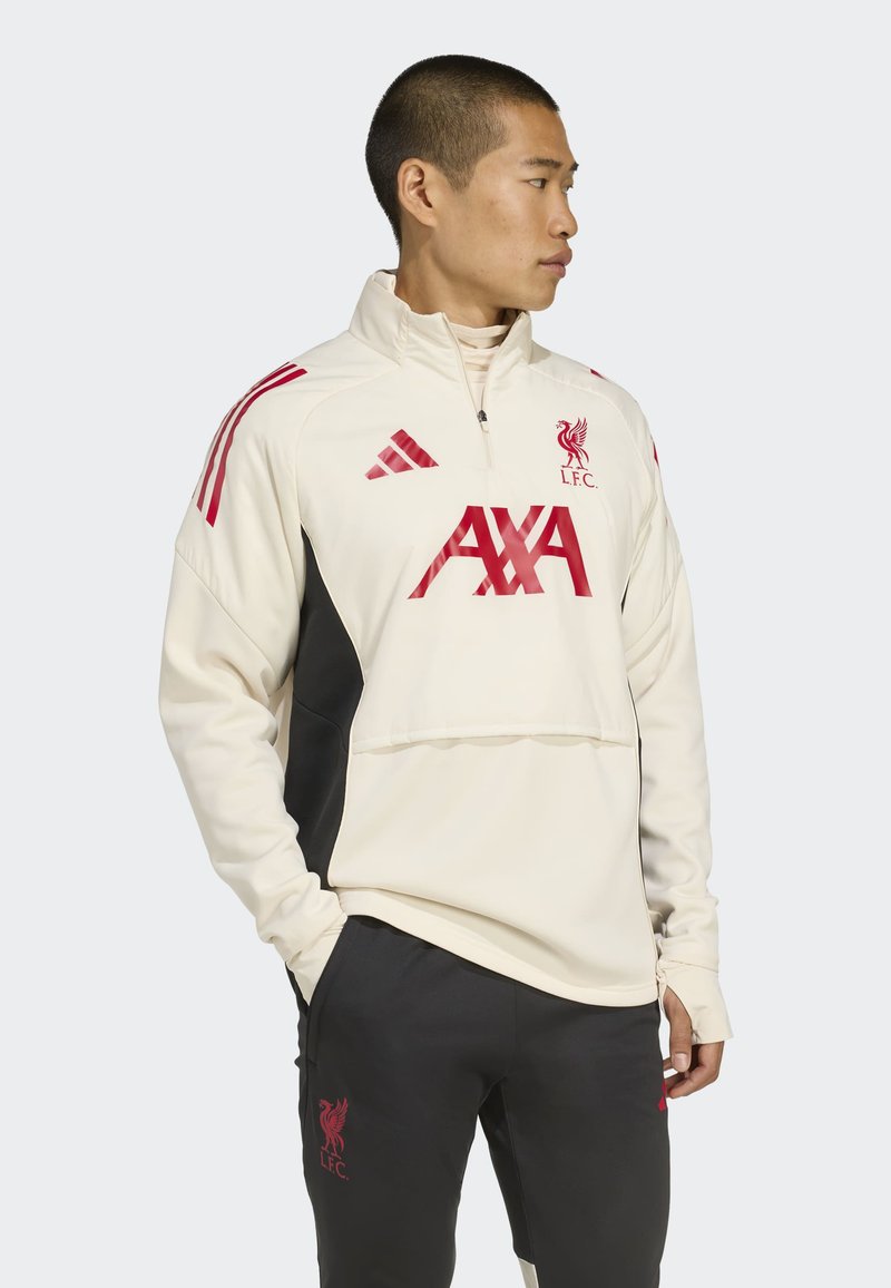 White and black athletic jacket with red accents, featuring a zip collar, embroidered logo, and contrasting panel design.