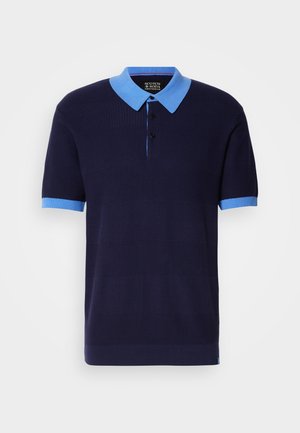 Short-sleeved polo shirt in navy with a light blue collar and cuffs. Features a textured pattern, three-button placket, and a brand label inside.