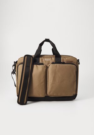 Brown nylon laptop bag with double zippered front pockets, padded handles, and removable shoulder strap. Black accents at the base and straps.