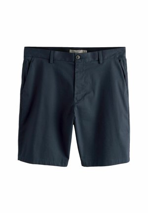 Granatowe, dopasowane szorty z szlufkami na pasek, zapięciem na guzik, bocznymi kieszeniami i ukrytym zamkiem błyskawicznym.