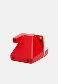 Red camera with a triangular shape, featuring a white accent, a viewfinder, and buttons. The exterior has a matte finish.