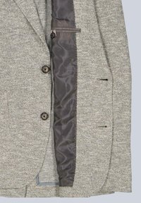 Gray textured blazer with a satin brown lining, two front buttons, and side pockets. Features a tailored cut and smooth interior finish.