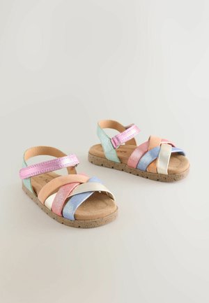 Multicolor sandals featuring glittery straps in pastel shades, a cork sole, and an adjustable strap for secure fit.