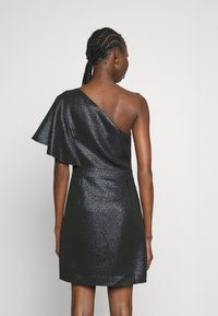 Svart klänning med en axel och utsvängd ärm, tillverkad av glansigt, strukturerat tyg. Figursydd passform med kort fåll.