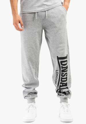 Gray sweatpants made of soft fabric, featuring a black "Lonsdale London" logo on the left leg, with an elastic waistband and cuffed ankles.