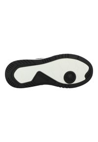 Semelle de chaussure de sport en noir et blanc, dotée d'une surface en caoutchouc texturée avec des motifs hexagonaux, un détail de branding circulaire et des bords renforcés.