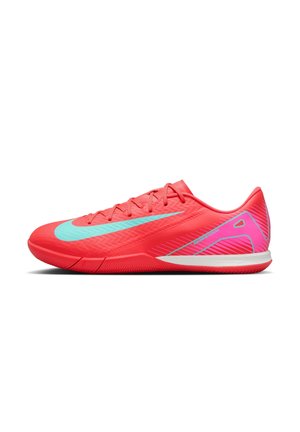 Bright red athletic shoe with light blue Nike swoosh, pink and white striped heel details, and lace-up design on white background.