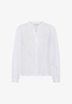 Fehér pamut blúz hosszú ujjakkal, gombos elülső résszel és keskeny csipke részletekkel az oldalakon. Kerek nyakkivágás és ráncolt mandzsetták.