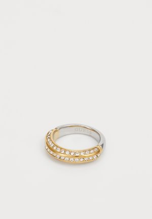 Gold and silver-tone ring with two curved bands, adorned with clear rhinestones set along the tops, smooth polished finish.