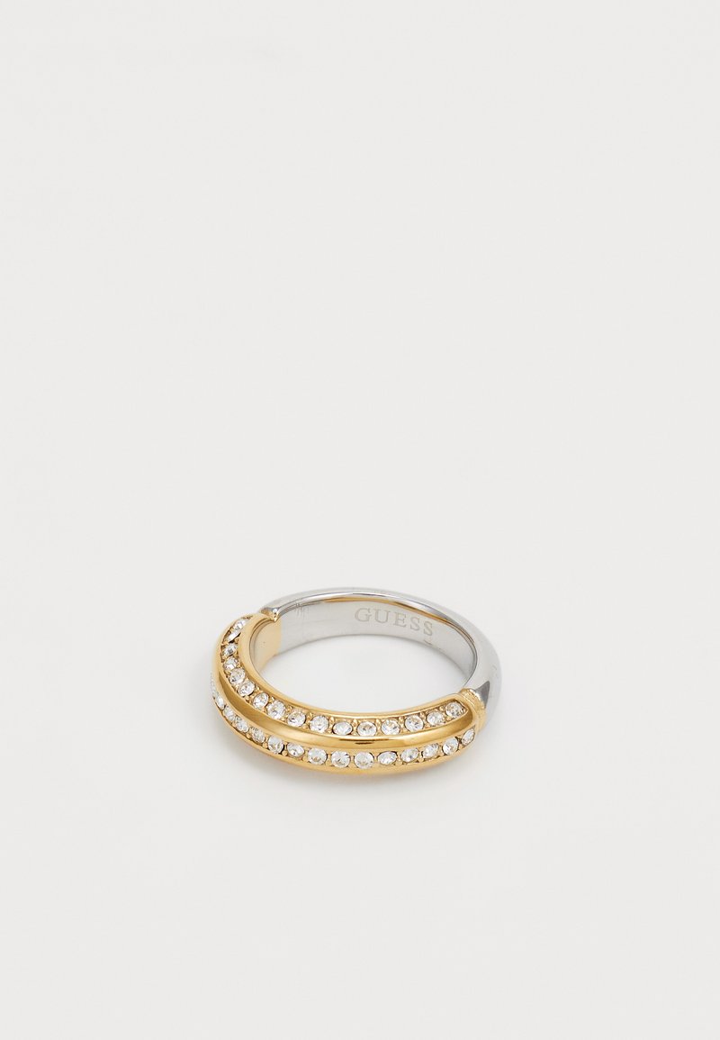 Anel em tom de ouro e prata com duas bandas curvas, adornado com strass transparentes dispostos ao longo das partes superiores, acabamento suave e polido.