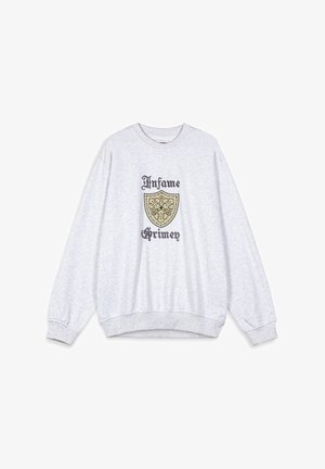 Sudadera gris con cuello redondo, mangas largas y puños acanalados. Presenta un gráfico de un escudo con las palabras "Infame Grimey" en negro y dorado.