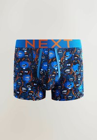 Boxer briefs en negro con un patrón de monstruos colorido, que presenta acentos en azul y naranja. La cinturilla elástica tiene "NEXT" en letras negritas.