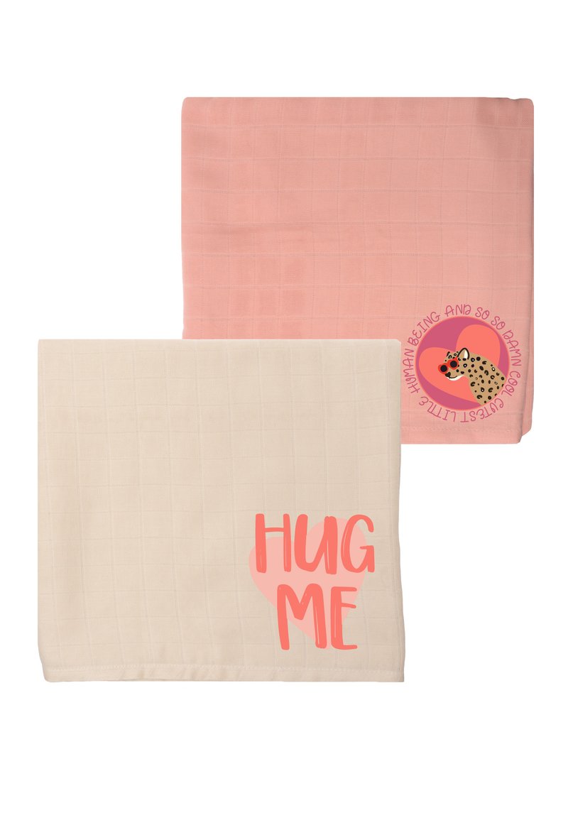 Two soft blankets: one light pink with a grid pattern, the other cream with a large "HUG ME" graphic in coral.