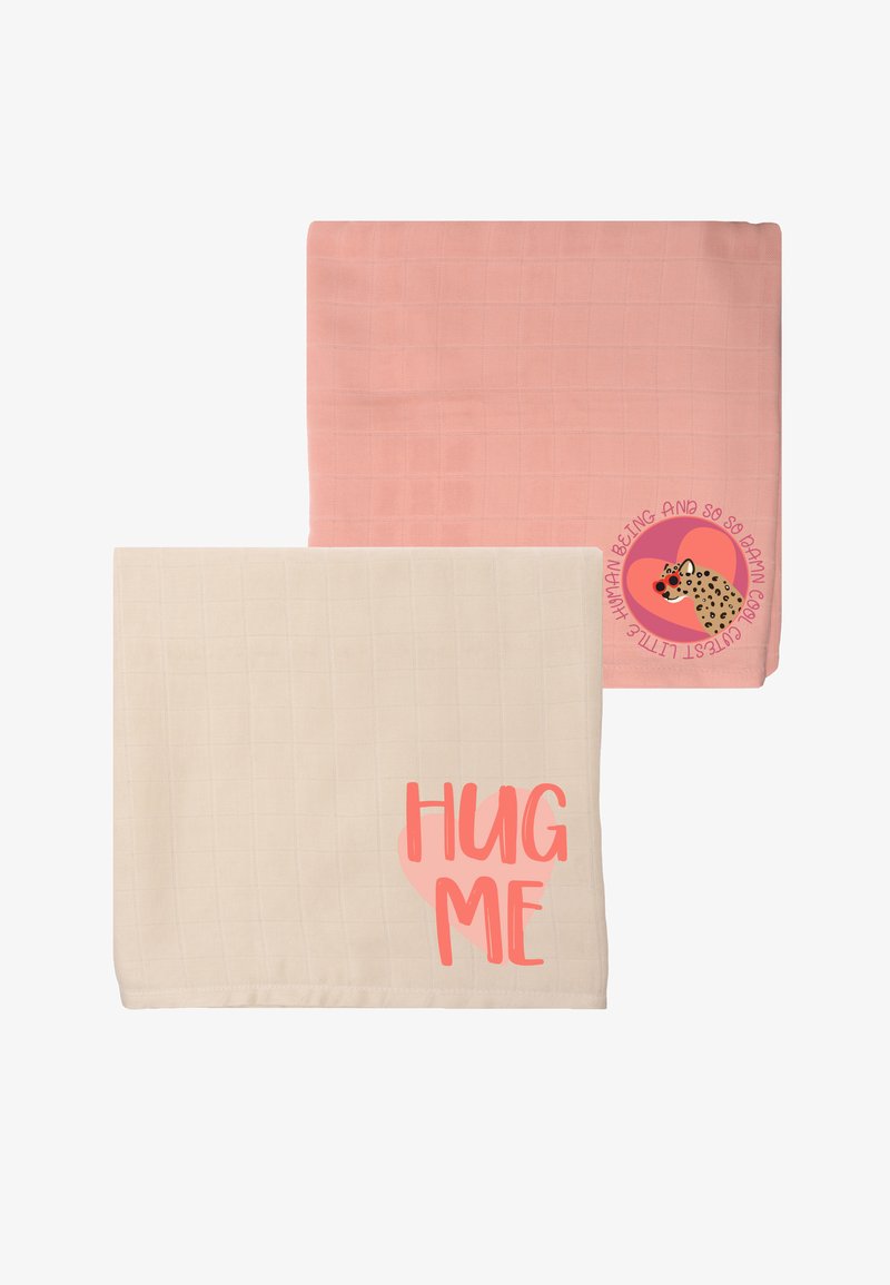 Two soft blankets: one light pink with a grid pattern, the other cream with a large "HUG ME" graphic in coral.