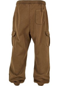 Brune cargo bukser med elastisk talje, elastiske manchetter og sidelommer. Lavet af et blødt stof med en glat tekstur.