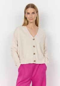 Beige V-neck cardigan with front buttons and long sleeves, styled with pink wide-leg pants, featuring a soft texture and relaxed fit.