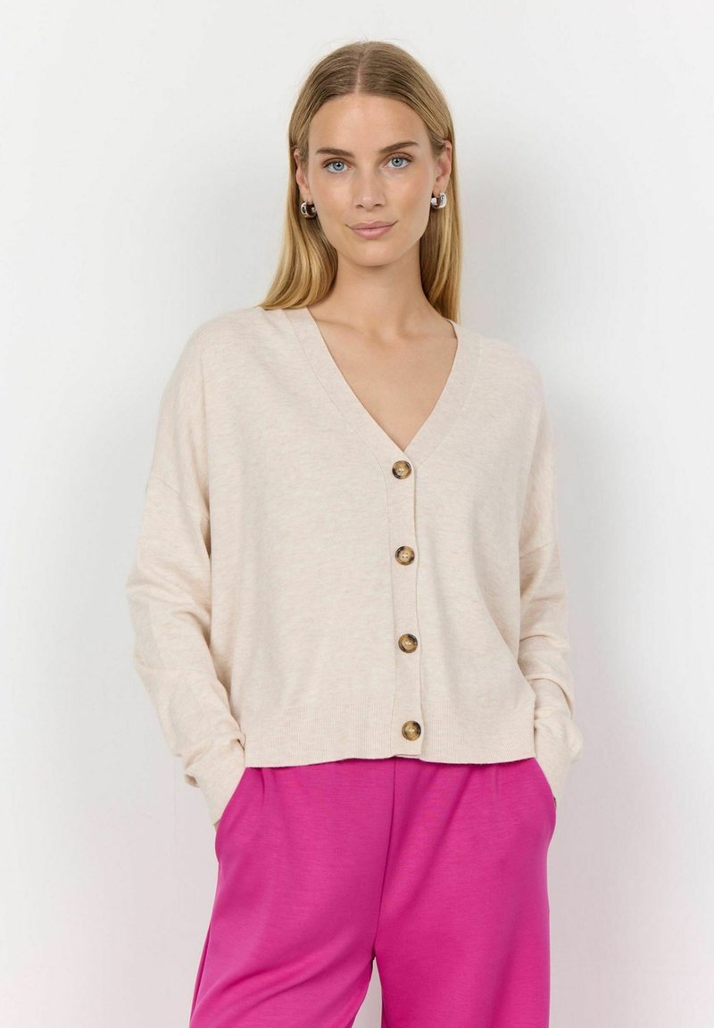 Beige V-neck cardigan with front buttons and long sleeves, styled with pink wide-leg pants, featuring a soft texture and relaxed fit.