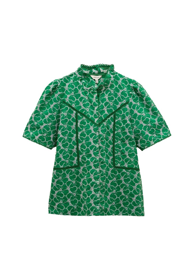 Camicia verde a maniche corte con motivo floreale e dettagli simili a pizzo. Presenta un colletto arricciato e due tasche frontali con accenti decorativi.