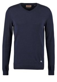 Pull bleu marine à manches longues avec col en V, poignets et ourlet côtelés, avec une petite étiquette en tissu près du bas.