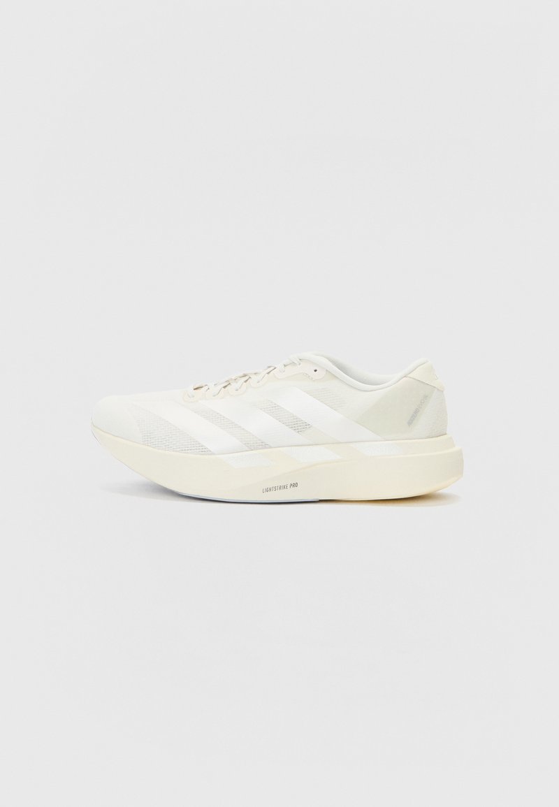 White athletic shoe with mesh upper, featuring three white stripes, a rounded toe, and a light-colored sole labeled "LIGHTSTRIKE PRO."