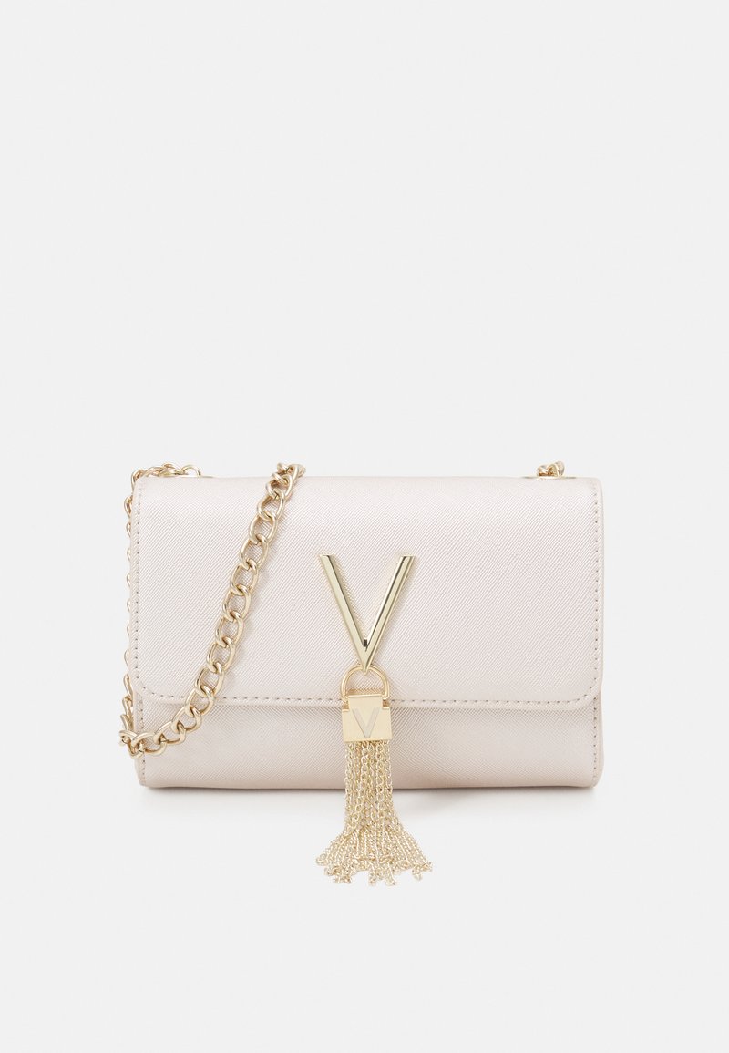 Beige faux leather bag with a gold chain strap. Features a V-shaped hardware accent and a decorative gold tassel. Compact rectangular design.