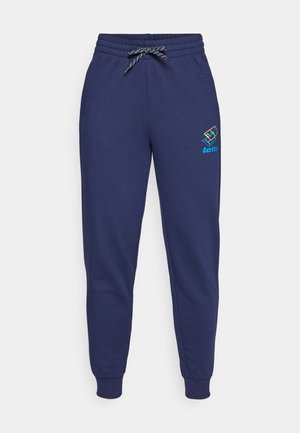 Navy blue sweatpants with a drawstring waist and ankle cuffs. Features a Lotto logo in vibrant colors on the left thigh. Made of soft fabric.