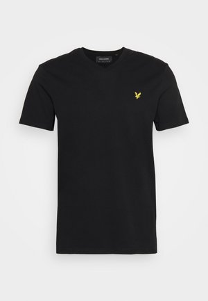 T-shirt de algodão preto de mangas curtas com decote em V e um pequeno logotipo de águia amarela no lado esquerdo do peito. Textura suave, corte normal.