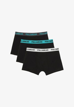 Trois boxers noirs pour hommes avec ceintures élastiques en noir, bleu sarcelle et blanc, chacun avec le logo "PULL&BEAR".