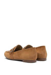 Brown suede loafers with a soft texture, rounded toe, low heel, and decorative buckle detail on the front. Standard flat sole design.