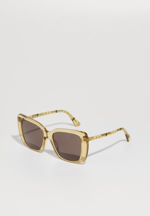 Yellow-tinted sunglasses with a square frame, dark lenses, and patterned temple arms. Transparent material with a glossy finish.
