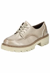 Scarpa stringata in pelle beige metallica con finitura texture, suola in gomma crema e borchie decorative sui lati. Punta arrotondata e dettagli di cucitura.