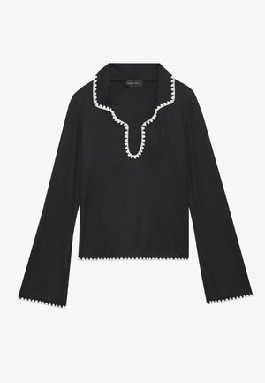 Black long-sleeve top featuring a scalloped white trim along the neckline and cuffs, made of textured fabric with a cropped design.