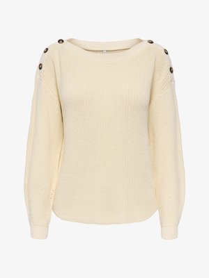 Cremefarbener Strickpullover mit langen, aufgeplusterten Ärmeln und jeweils drei dunklen Knöpfen auf jeder Schulter.