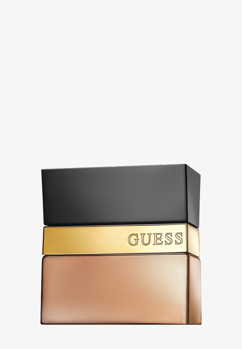 Rektangulær parfymeflaske med svart kork, gullfarget midtstripe med gravert "GUESS" og frostet lys brun glassbase.