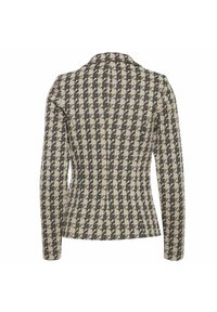 Sakou s vzorem houndstooth v béžové a černé barvě, s upraveným střihem, dlouhými rukávy a šikmým límcem. Viditelný detail texturované tkaniny.