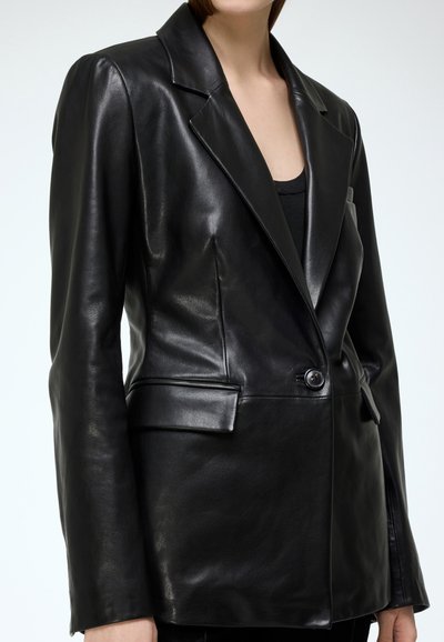 Black leather blazer with notched collar, single button closure, and two front pockets. Smooth texture and tailored fit.