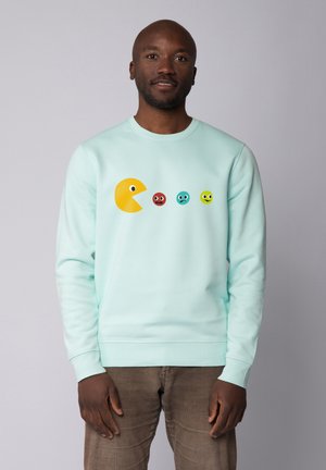 Mintgroene sweatshirt met een grote gele Pac-Man graphic en vier kleurrijke spookgezichtjes in rood, blauw, lichtgroen en geel.
