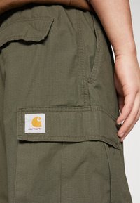 Carhartt WIP JET PANT - Hlačami s stranskimi žepi - cypress rinsed
