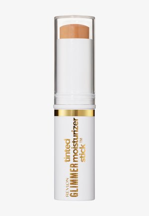 Revlon getinte Glimmer moisturizer stick in een witte tube met een doorzichtige dop, met een beige kleurig product zichtbaar binnenin.