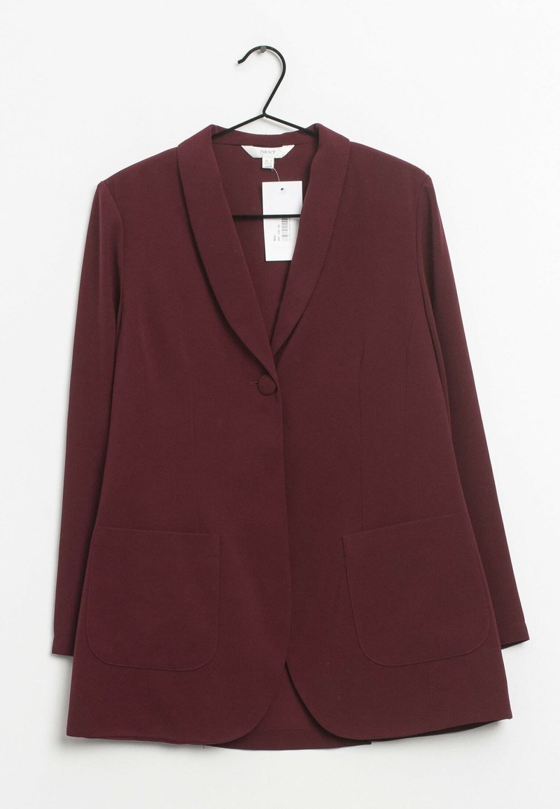 Blazer femme rouge foncé à manches longues, fermeture à un bouton, deux poches avant, suspendu sur un cintre noir sur fond blanc.