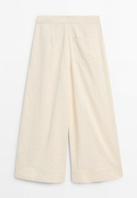 Wide-leg cream colored pants with a back pocket, high waist, and a subtle seam detail near the hem.